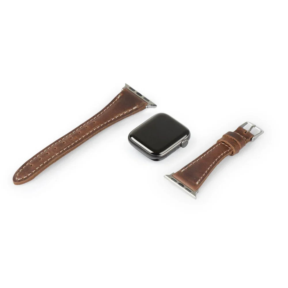 Brown leather Apple Watch strap and watch case on white background