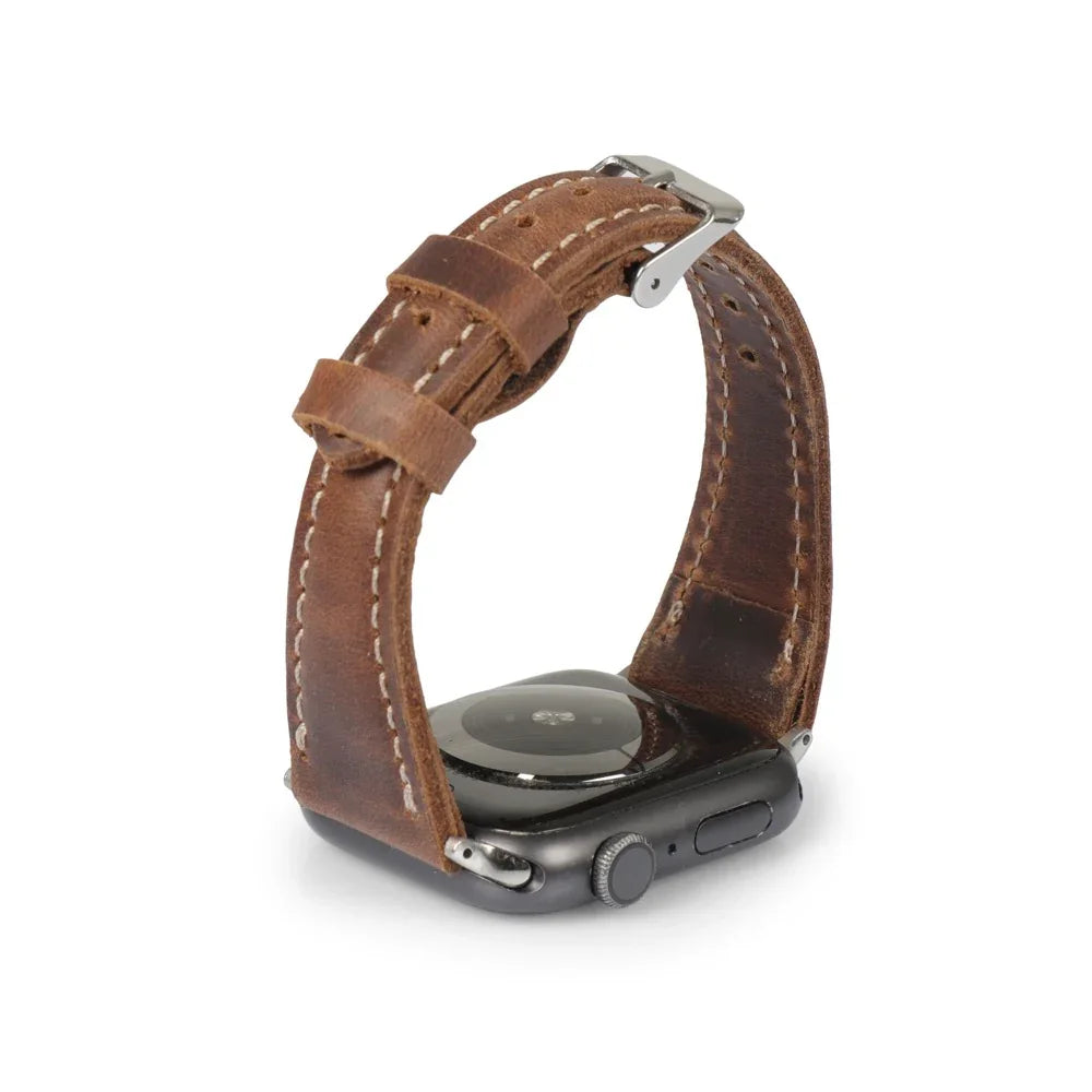 Tan full-grain leather Apple Watch strap with silver buckle, shown on a black smartwatch.
